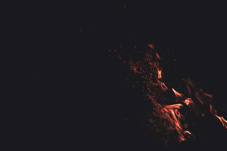 motion fire flame sparkles in dark environment space background copy space