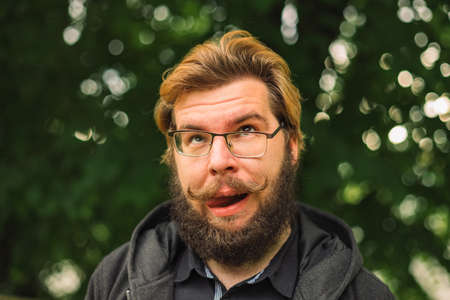 foolish portrait funny grimace male face photography of middle adult bearded person in glasses...
