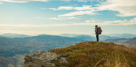 travel life style backpacker man stay and enjoy by beautiful peaceful moody highland mountains landscape scenic view in autumn season time of October monthの写真素材
