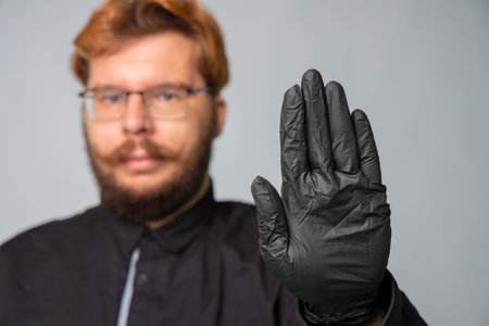 male portrait doctor hand stop sign global health care crisis virus pandemic concept studio...
