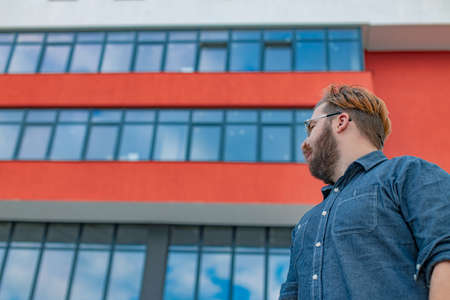 white man construction building company clerk person on architecture exterior facade urban background landmark viewの写真素材