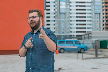 middle adult constructor man funny portrait pose in construction building area industrial space landmark unfocused background viewの写真素材