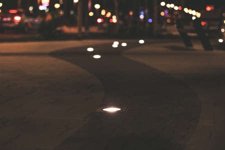 soft focus night street promenade walking alley paved road and lamps illumination with unfocused background urbanの写真素材