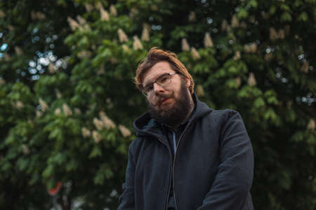 ugly middle age bearded man portrait in park outdoor environment spaceの写真素材