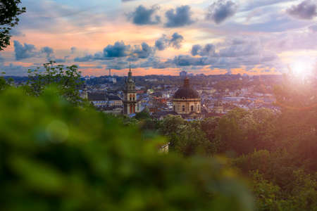 European city Lviv Ukraine landmark scenery from top view point historical center cathedral dome and town hall tower in colorful bright evening sun light and glare time wallpaper pocter pictureの写真素材