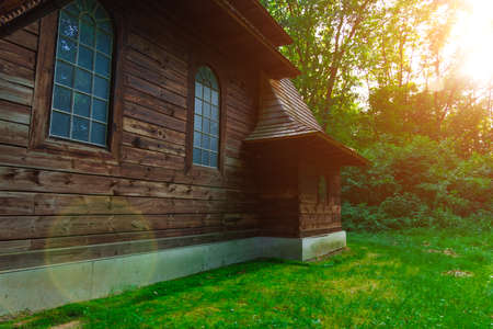 wooden church ancient religion building in wood land environment space with sun light and glare effectsの写真素材