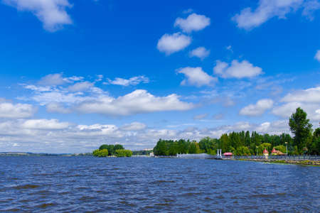 waterfront of Ukraine city summer landscape of river shore with coast line and island in clear weather day time and blue sky background spaceの写真素材