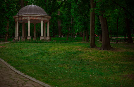 park walking alley for promenade with column gazebo architecture object in cloudy dramatic weather time without peopleの写真素材