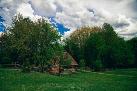 picturesque village country side landscape scenery view early autumn September season day time wood land edge cloudy weather before rainの写真素材
