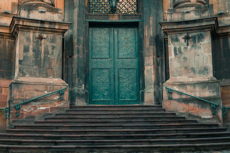 gothic architecture cathedral entrance symmetry exterior facade stairway and door in muted soft colorの写真素材