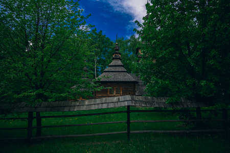 wooden church of ancient Slavic culture architecture museum object for travel tourism sightseeing in morning dusk lighting in spring time weatherの写真素材