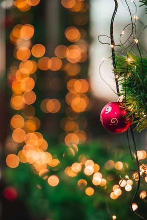 vertical photography outdoor decorated space with December holidays eve objects garland, lamps and ball toy, soft focus concept, bokeh backgroundの写真素材