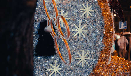Christmas decorations with sparks and garland lamps in December month of evening city street urban environmentの写真素材
