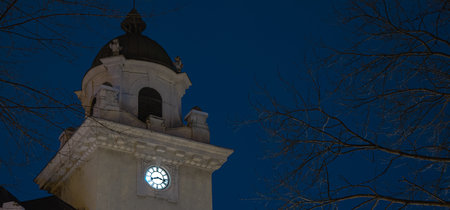 winter night town tower with wall clock simple old architecture building panoramic picture with soft...