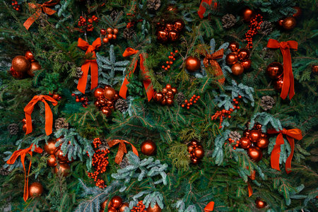Christmas background evergreen tree decorations red balls and ribbons and green needle branches...