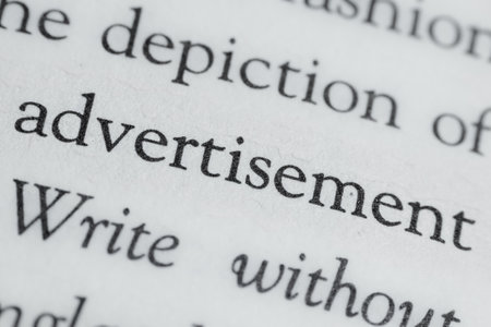 printed book macro photography text conceptual picture close up paper white textured surface background view with word advertisementの写真素材