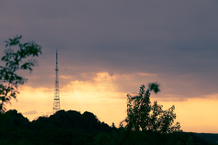 sunset cloudscape landscape dramatic natural lighting hill peak with tv tower