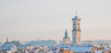 winter panorama old European town hall old architecture tower in Lviv Ukrainian city scape in the middle of December monthの写真素材