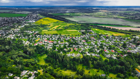 aerial outskirts country side rural view village cottages living district for people in edge of green park zone and fields area in spring time clear weather day in April monthの写真素材