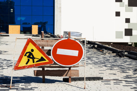 forbidden no entrance sign road works foreground urban landmark building progressの写真素材