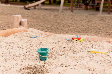 empty sand box playground for children with plastic toys bucket and tractor objectの写真素材