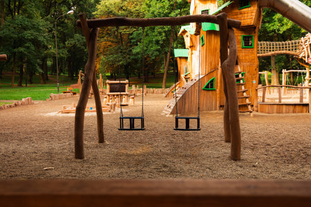 amusement park wooden carousel hanging swing for kids playground space without people here empty pointの写真素材
