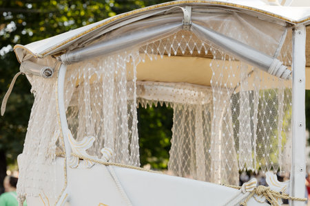 classic vintage carriage stagecoach royal touristic traditional United Kingdom cultural destination attraction site white curtain and bright frame work transport mode object foregroundの写真素材