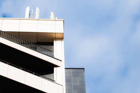 modern building panels triangle pattern architectural shape view with balcony and corner of roof...