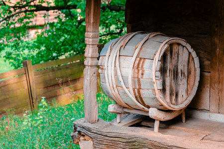wooden barrel on a porch of rustic village house wine cellar fermenting beverage conceptual image