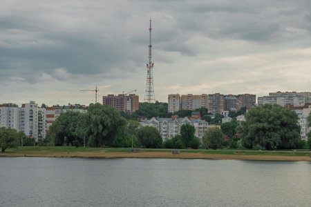 gray city scape Eastern Europe past Soviet Union country panel concrete architecture buildings landmark panorama with empty beach waterfront space river water foregroundの写真素材