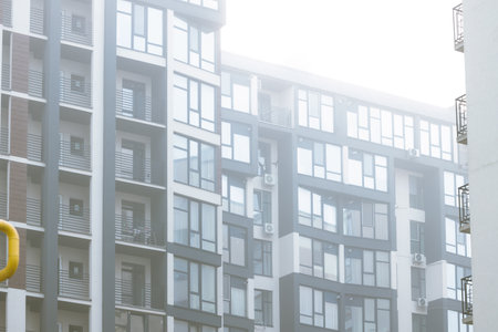 living building downtown district modern architecture apartment facade balcony and windows local close up city scape in morning mist natural conditionの写真素材