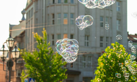 soap bubbles summer city scape happiness bright vivid colorful urban view with focus on foreground spaceの写真素材