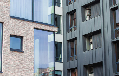 building narrow densely build up modern city street of living high buildings close up facades view...