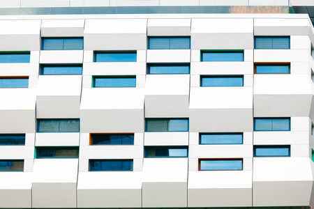 Huge facade exterior modern skyscraper office wall white background and cells windows objectsの写真素材