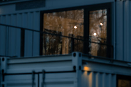 unfocused blur metallic frame in the dark barn frame window and lamp warm illumination dusk low lighting conditionの写真素材