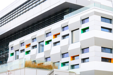modern architecture design building office white facade walls and colorful windows exterior city scape conceptの写真素材