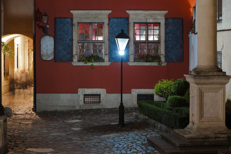 night Europe city scape cobble stone old street urban view long exposure night picturesque place colorful facade buildingsの写真素材