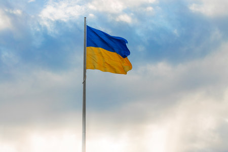 Ukrainian waving flag independence day wallpaper concept poster with light glare empty copy space and blurred sky background viewの写真素材