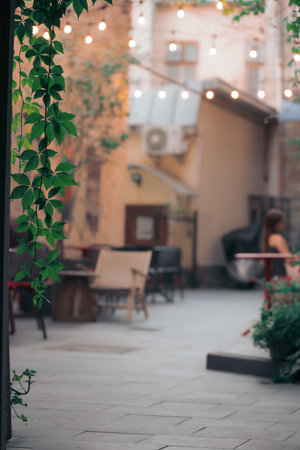 cafe outdoor patio tables background silhouettes resting people vertical picture conceptの写真素材