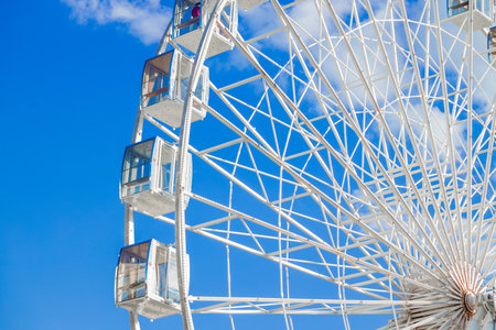 Ferris wheel amusement park metallic construction frame attraction panoramic format of vivid and blue colors pictureの写真素材