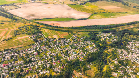village settlement aerial view country side land along agriculture field in September autumn monthの写真素材