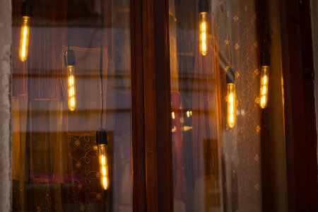warm bulb garland light window background glass smooth solid surface with slightly reflection from interior cozy holiday season concept pictureの写真素材