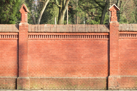 brick fence outskirts abandoned building site red building material construction with background blurred nature viewの写真素材