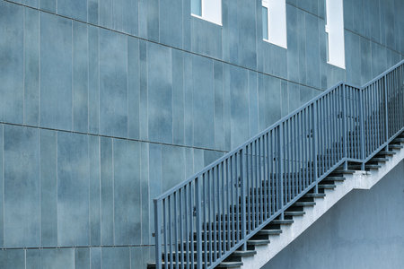 stairs metallic construction factory indoor space wall panel perspective background surface empty place patternの写真素材