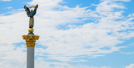Monument of Independence Ukraine Kyiv capital heritage view of high rise pillar sculpture back to camera on panorama sky background empty space for advertising text conceptの写真素材
