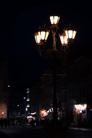 dark night city street with electric light lantern black background vertical pictureの写真素材