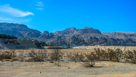 Prairie panorama desert dry land country side landscape with background bridge and mountain range horizon view with clear weather blue sky hot day timeの写真素材