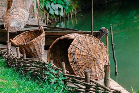 crafted woven baskets in rural village pier summer nature south eastern asian region close up outdoor view near watersの写真素材