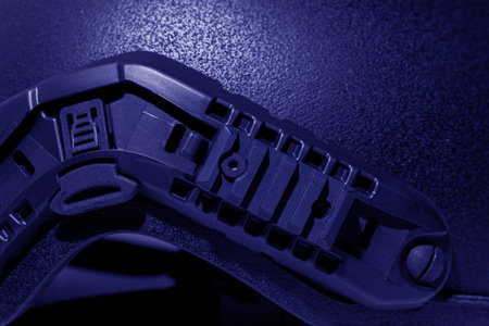 This extreme close-up showcases the intricate design and functionality of a modern tactical helmet's accessory mounting system, highlighting its modularity and rugged constructionの写真素材