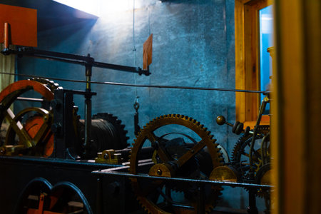 Intricate gears and mechanisms of an old clock tower, showing complex engineering and historical...